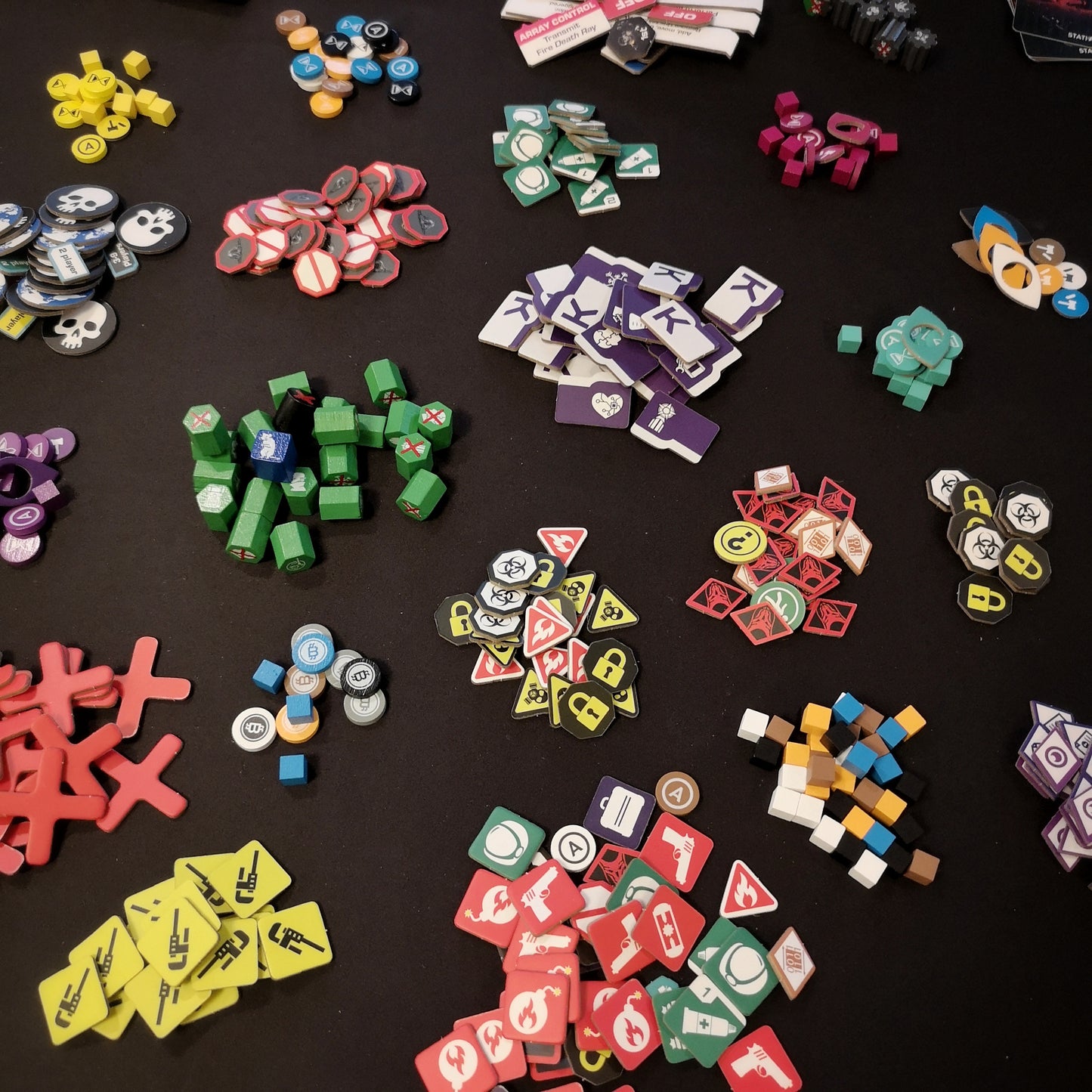 Picture of different colored components, stacked in piles on a black table.