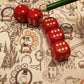 Close up of red dice and a green pen on top of tha game board.