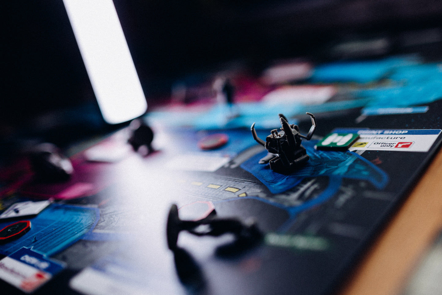 Dramatic picture of components on the game board with heavy shadows.