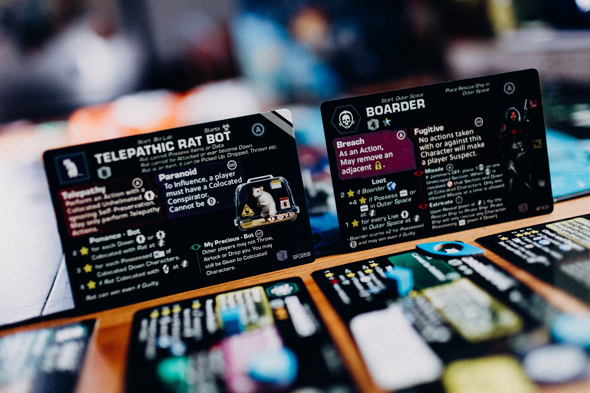 Close up of cards standing next to other game components.