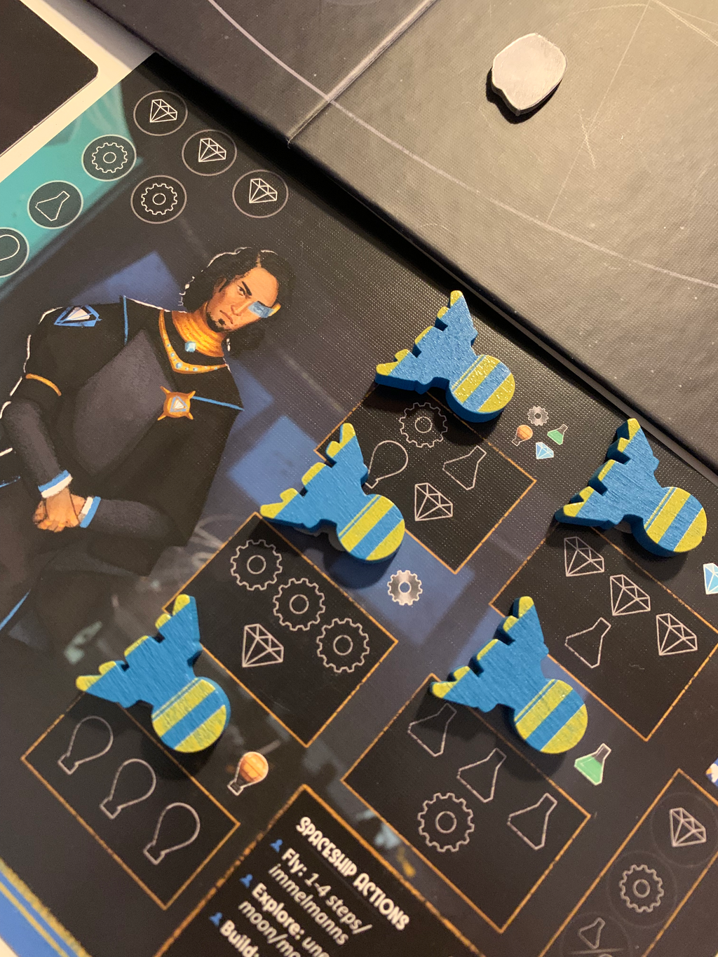 Dawn on Titan Board Game -  blue space ship pieces set up on their player board