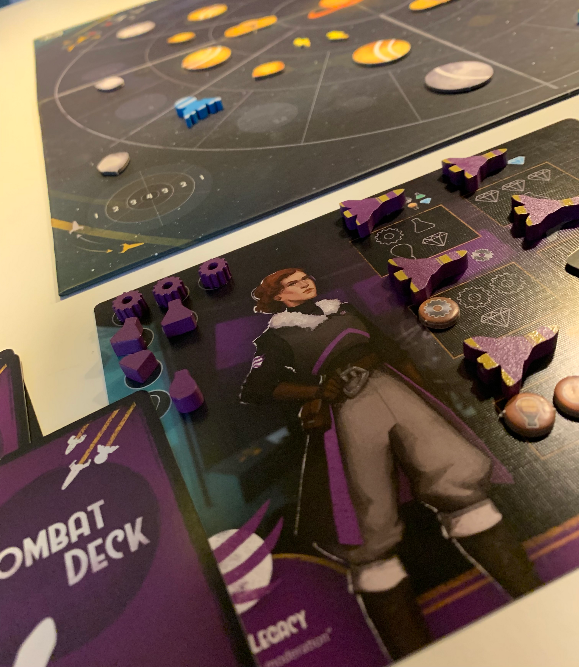 Dawn on Titan Board Game - purple space ship pieces set up on their player board