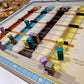 Galenus Board Game - Competition track with competition figurine filling up the player's respective columns