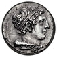 Galenus metal coin - One side of the metal coin featuring the side profile of a face in the romanesque style