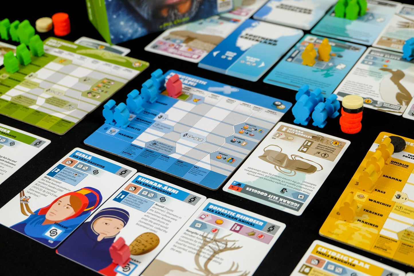 Greenland board game character cards and character figurines arranged in a playing position on a table