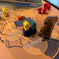 Sammu-Ramat Board Game - Close up view of the empire meeples, and punchout characters displayed on the board