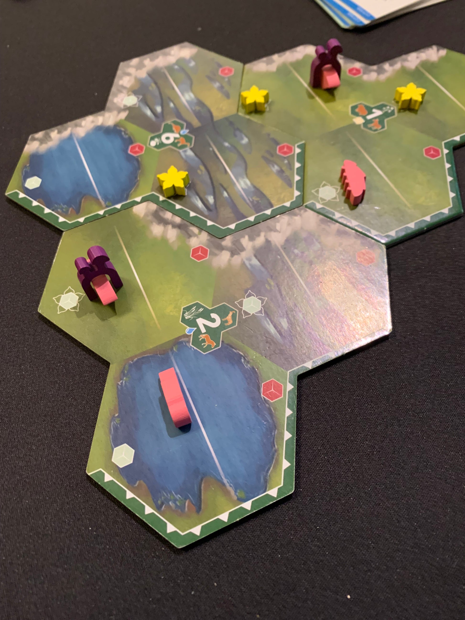 Bios: Mesofauna board game - Craton punchout accompanied by fossil chits and yellow flower tokens