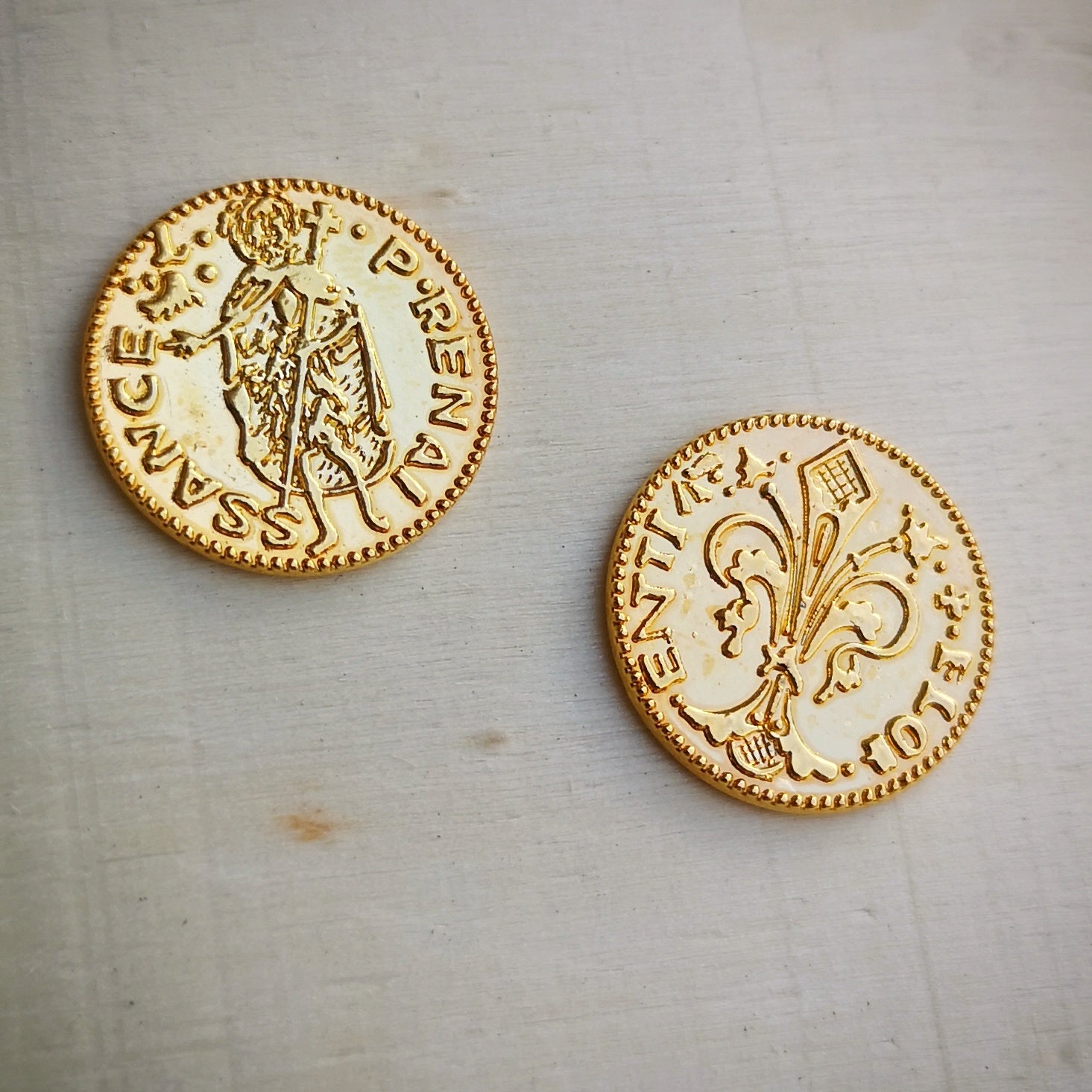 Expanded view of two metal game coins