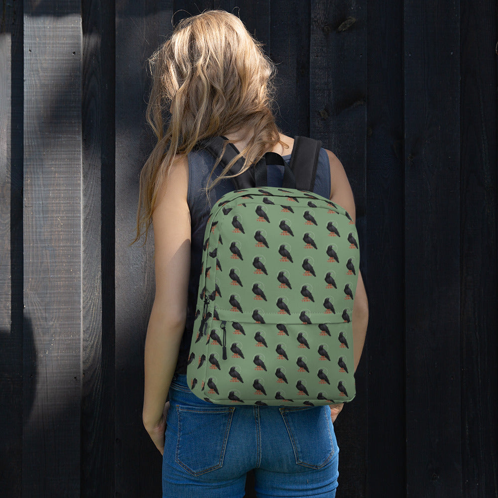 PAX Viking: Raven Backpack - Raven print bag being work by the shoulder straps